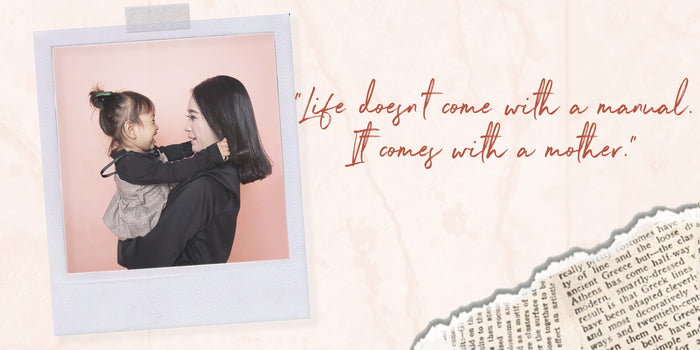 A polaroid image of a mother and child on a scrapbook background.